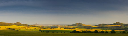 Ceske stredohori, north Czech hill landscape at dramatic sunset light. Nature, weather panoramic backgroundの写真素材