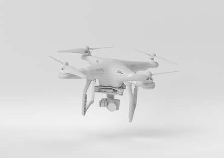 white drone quadcopter with digital camera floating on white background. minimal concept idea. monochrome. 3d render.の写真素材