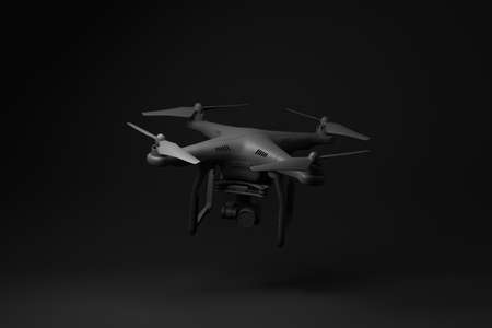 Black drone quadcopter with digital camera floating on black background. minimal concept idea. monochrome. 3d render.の写真素材