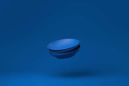 Blue Dish plates floating in blue background. minimal concept idea creative. monochrome. 3D render.の写真素材
