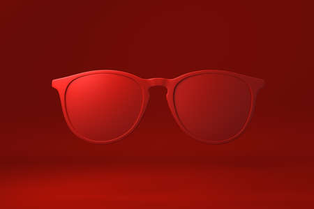 Red Glasses floating in red background. minimal concept idea creative. monochrome. 3D render.の写真素材