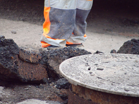 Industrial worker working on a road construction site. Close up.