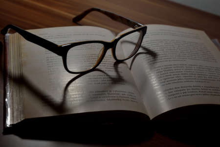 glasses lying on an open book