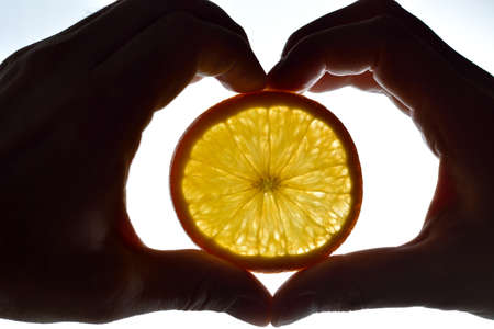 Hands and orangeの写真素材