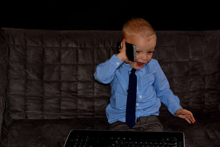 Little boss with phoneの写真素材