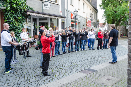 Hattingen old town, Nrw, Germany - October 10, 2014: Members of a marching band chapel to open a restaurant in the old town of Hattingen. In Vordergurnd the conductor.のeditorial素材