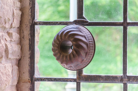 Cake baking pan front of an old industrial windows.の写真素材