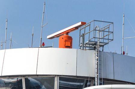 Air traffic control tower with radar equipment at an airport.の写真素材