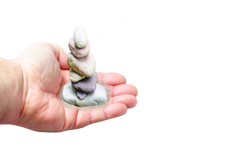 Gravel pile, small stone tower in hand. Symbol of balance and harmony.の写真素材