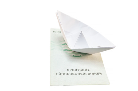 Document from the German boat driving license inland. With small paper ship as a symbol.の写真素材
