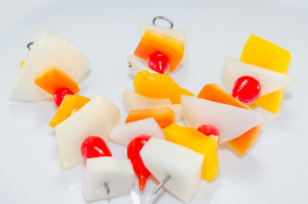 Vitamin-rich vegetable skewers with pieces of onion, yellow pepper and cherry tomatoes.の写真素材