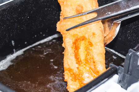 Fresh coley fillet done in beer batter for the fryer.の写真素材