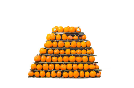 Decorative pumpkins stacked in a pyramid shape. Isolated.の写真素材
