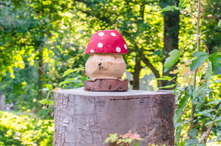 Fly agaric manufactured from wood on a tree trunk.の写真素材