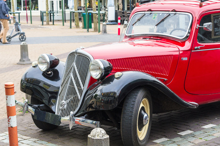 Renesse, Zeeland, The Netherlands - June 14 2015: Age Citroen 11 CV in Renesse city center on the main shopping street.のeditorial素材