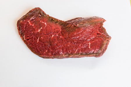 Fresh raw beef steak on white backgroundの写真素材
