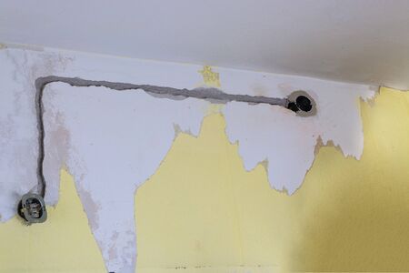 Electrical renovations in an old house. The installation of new power lines cable for power, Internet or telephone.の写真素材
