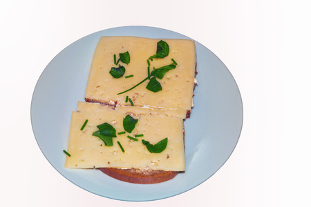 Simple #cheese bread with fresh herbs on a white plate against neutral background.の写真素材