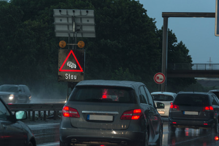 Danger of a traffic jam in heavy rain. Severe weather on the highway and bad driving conditions.の写真素材