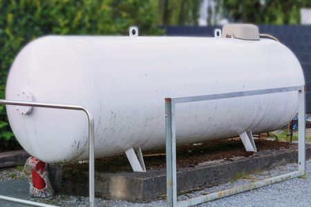 Large propane gas tank or liquid gas tank in a garden.