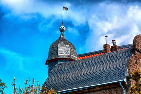 Gable of a beautifully restored house against a blue skyの写真素材