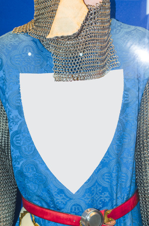 Medieval knight armor with chain mail and coat of arms on blue shirtの写真素材