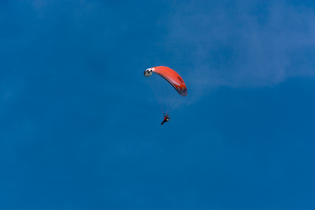 HEILIGENHAUS, NRW, GERMANY - JUNE 08, 2017: Paraglider aviator in front of a blue sky