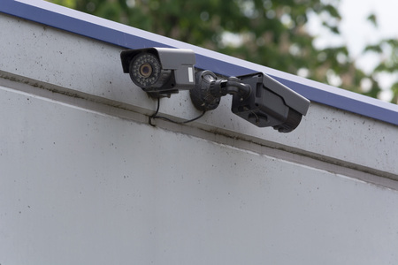 Two CCTV surveillance cameras. Concept security in the office building.の写真素材