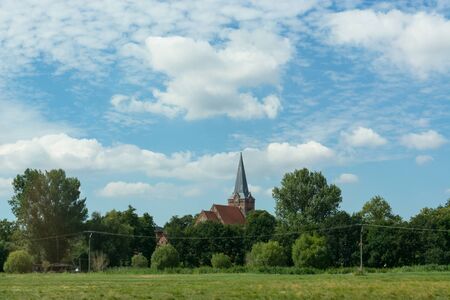 Countryside panorama blue sky Village church in the backgroundの写真素材