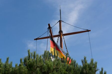 Wooden boat on the shore of a lake in the reeds              の写真素材