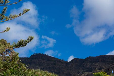 Mountains on the coast between Puerto de Mogan and Puerto Rico. Layers of volcanic rock.の写真素材