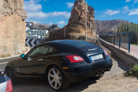 CRAN CANARIA, PUERTO RICO - NOVEMBER 16, 2019: Chrysler Crossfire Coupe in a parking lot above the marina in Puerto Rico on Gran Canaria.のeditorial素材