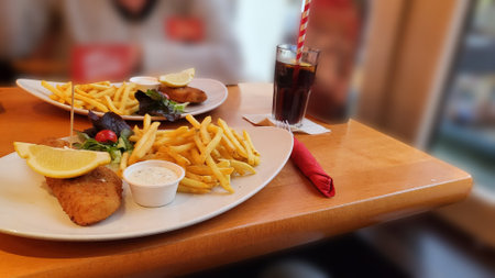 Fish and chips. Close up of crispy breaded deep fried Alaska pollock fillets in breadcrumbs served...