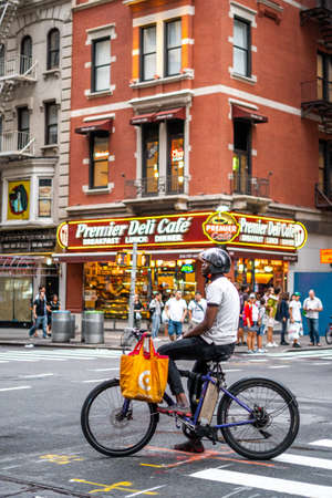 A man with bycicle on street near times sqaure in Manhattan , New york city , United States of America - September 1 , 2018のeditorial素材