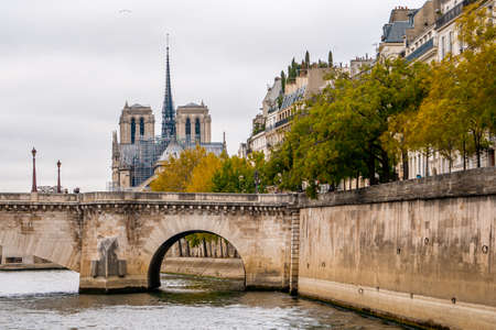 Nice view from Paris Seien river cruise tour and Notre dam cathedral during Autumn season evening . One of the most famous activities which locate in the heart of Paris , Franceのeditorial素材