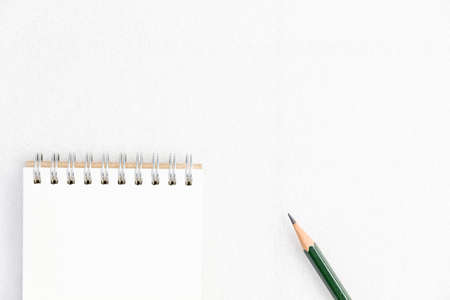 Notepad and pencil isolated on white background.