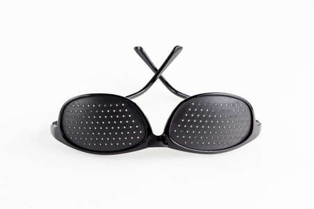 Pinhole eyeglasses help relaxing weary eyes, on white background.の写真素材