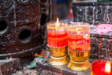 Chinese people worship with incenses, candles and oil lamps.の写真素材