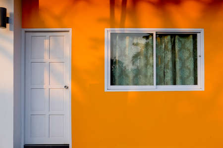 Vibrant color wall with door and windows.の写真素材