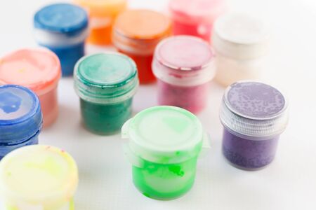 bright gouache paints on white background,multi-colored tubes of paintsの写真素材
