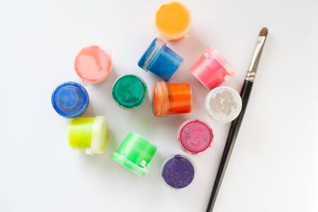brush and a set of multicolored gouache on a white background top view  flat lay close upの写真素材