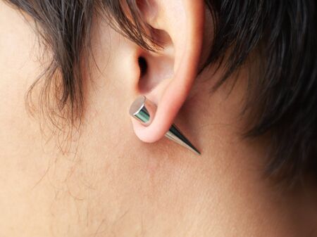 piercing in the ear, tunnels in the ears of a young man lifestyle close ipの写真素材