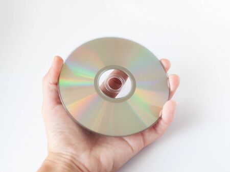 cd compact disc with film and music, dvd disc in hand on white background close-up
