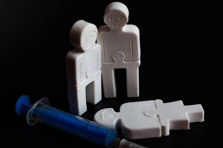 illustration of the effects of addiction. little plastic men with a syringe. concept close-upの写真素材
