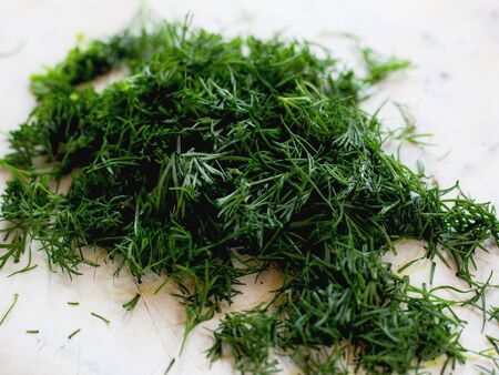 sliced fresh dill on a light background close-upの写真素材