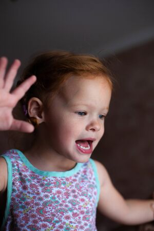 portrait of a beautiful little girl with red hair close-upの写真素材