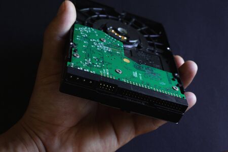 old computer hdd hard drive on a dark background close-up