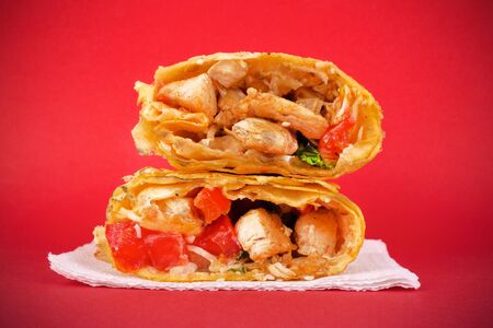 Fast food concept : chicken shawarma on a red background closeupの写真素材