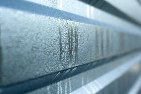 copy space on silver wet corrugated board,ribbed metal background.
