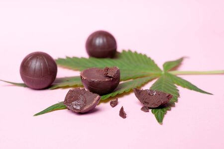 cannabis chocolate candies.pieces candies on a marijuana leaf.drug sweets.